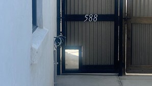 A gated entrance with the number 588, a small window, and a concrete pathway leading to a building. - Newer Build-Just a Block to Main St.-Mountain Views (Buena Vista)