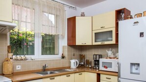 A kitchen with a sink, stove, microwave, and refrigerator. - Twin Combo by Interhome (Balatonboglar)
