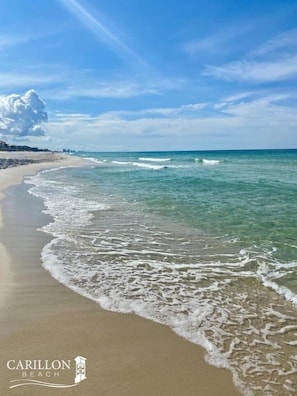 A beach with clear water, waves, and a logo for Carillon Beach. - Carillon Beach 30A - 1st flr studio condo private beach - Pets ok - FULL kitchen (Rosemary Beach)