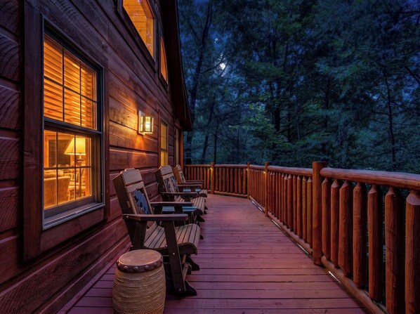 A wooden cabin with a deck, outdoor seating, and a view of a forested area. - MoreDISCOUNTS🌄
COZY PEACEFULSeclusionCLOSE to FUN 2BR+Loft 170+ 5 star Reviews (Sevierville)