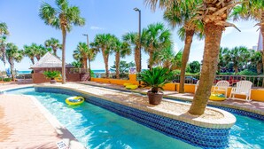 A swimming pool with a blue mosaic border, surrounded by palm trees and a beach view. - BEACHFRONT DIRECT OCEANFRONT PENTHOUSE ONTHE GOLDEN MILE MYRTLE BEACH GRANSTRAND (Myrtle Beach)