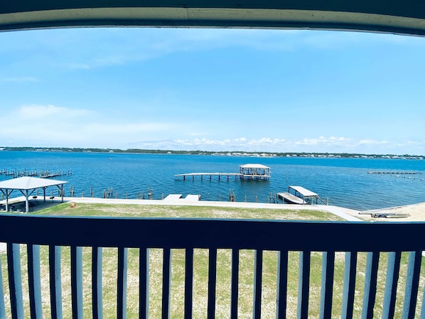 A view of a marina with docks and a covered seating area.