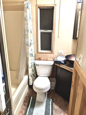 Bathtub, towels, soap, toilet paper