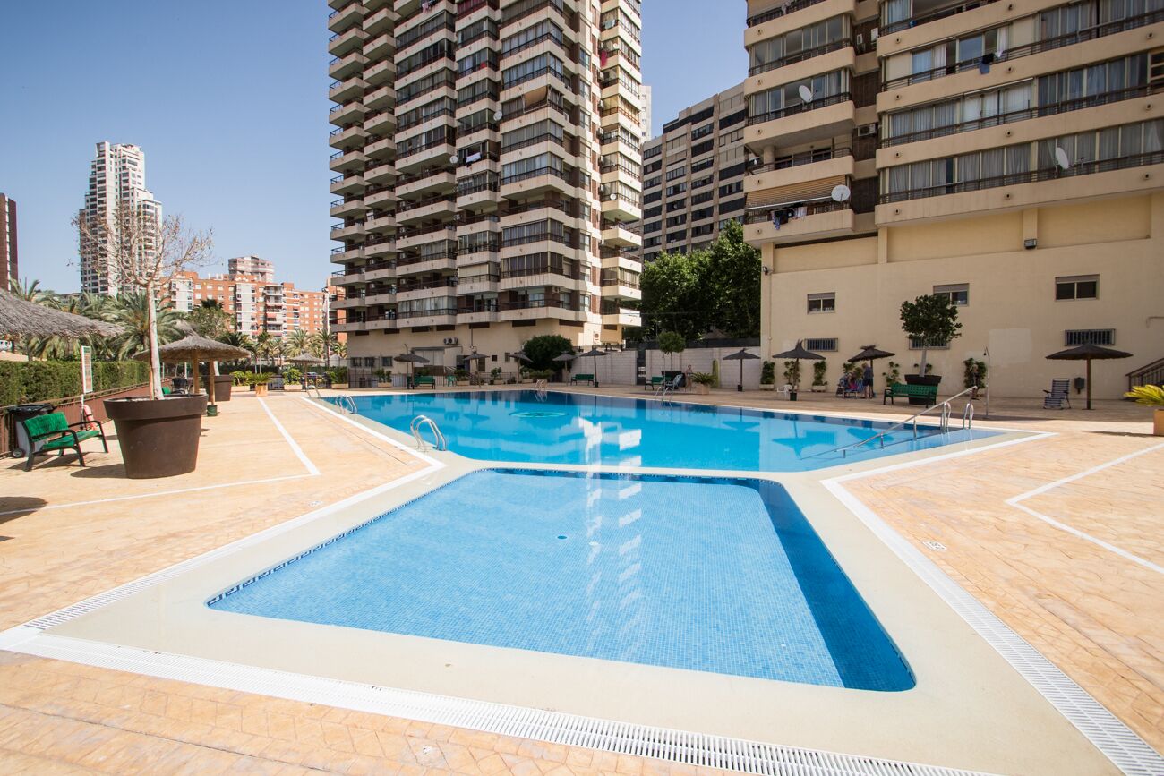 A swimming pool surrounded by high-rise residential buildings.