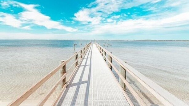 A wooden pier extending into calm waters under a clear sky. - Footsteps away from beautiful beaches 🏖🏝⛱ (Navarre)