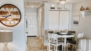 A modern living room with a dining area, featuring a clock, a lamp, and a sofa with patterned cushions. - Footsteps away from beautiful beaches 🏖🏝⛱ (Navarre)