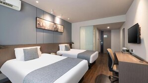 A hotel room with two beds, a desk, a chair, a flat-screen TV, and an air conditioning unit. - Jinjiang Inn Select (Tianjin)