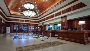 A hotel lobby with a wooden ceiling, a reception desk, and a chandelier. - Hilton Hawaiian Village Lagoon Tower (Honolulu)