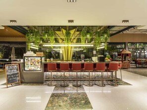 A modern bar area with a counter, bar stools, and a chalkboard sign. - Mercure Trabzon Hotel (Trabzon)