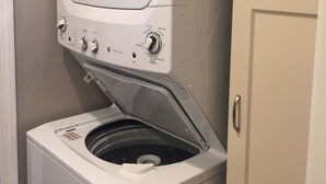 A front-loading washer and dryer unit with control knobs and a start button. - Lauren's Loft in Historic Downtown Pleasant Hill (Pleasant Hill)
