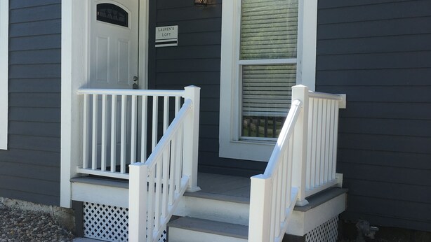 A house with a front porch, a door, a window, and a sign that reads "Lauren's Loft". - Lauren's Loft in Historic Downtown Pleasant Hill (Pleasant Hill)