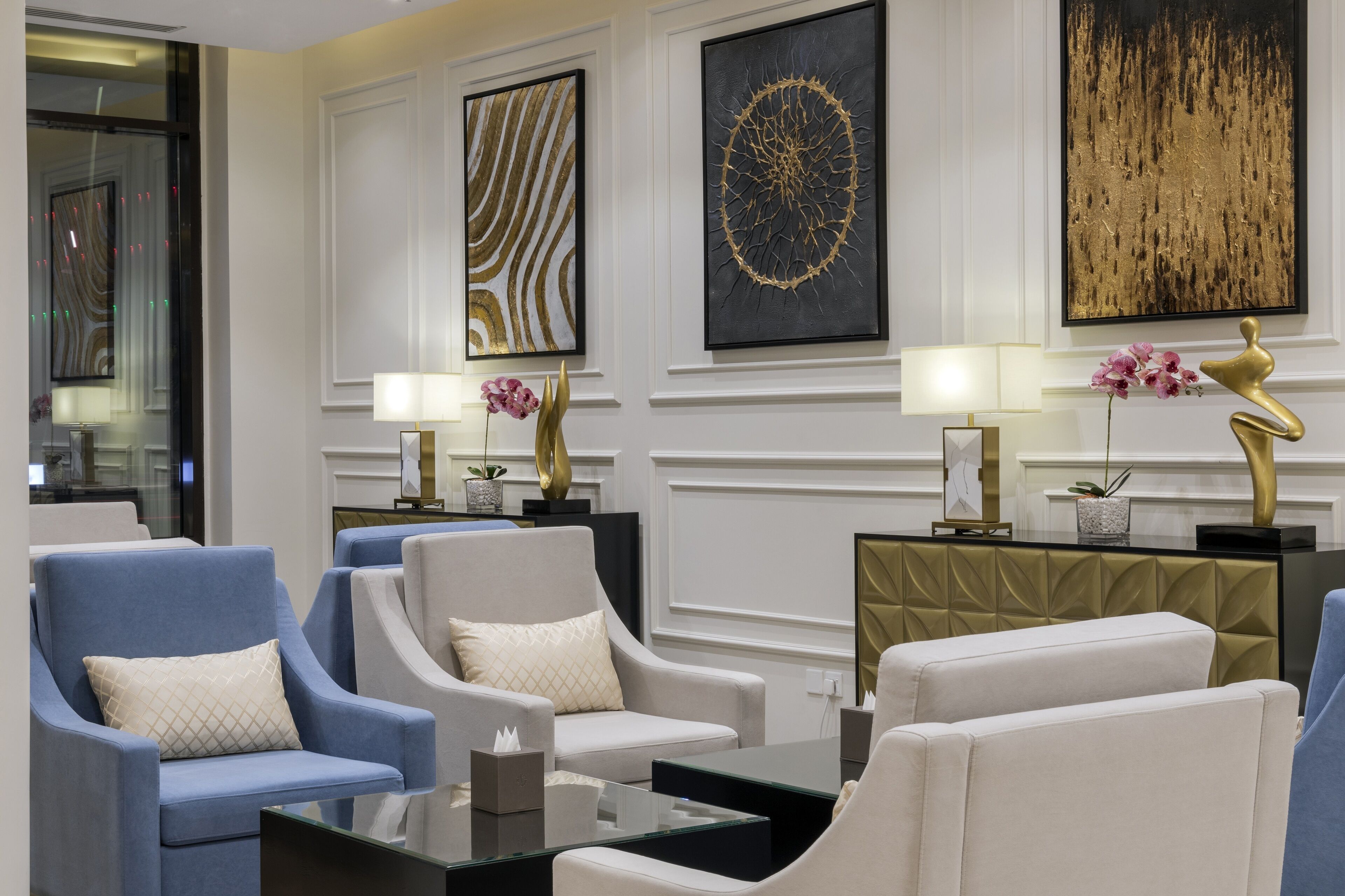 A modern lobby with seating areas, decorative artwork, and a well-lit ambiance.