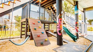A children's play area with a wooden slide, climbing wall, and swing set. - Palazzo 360 5bdr/5 bath with a heated pool sleeps 18 (Murrells Inlet)