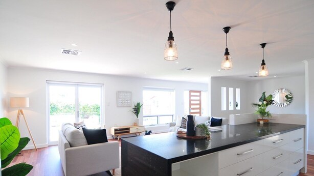 A modern kitchen with a central island, pendant lighting, and large windows providing natural light. - Beach Haven - Modern home located right in town, you wont get better. (Robe)