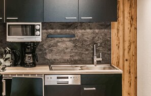 Fridge, stovetop, dishwasher, coffee/tea maker