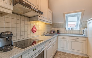 Fridge, stovetop, dishwasher, coffee/tea maker
