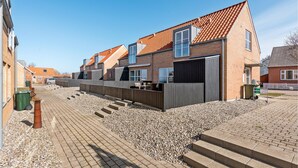 A residential area with houses featuring red-tiled roofs and brick exteriors. - Gorgeous home in Tranekær with kitchen (Tranekær)