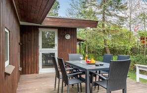 Enjoy a meal or casual gathering in this cozy dining area surrounded by a lush garden.