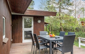 Enjoy a meal or casual gathering in this cozy dining area surrounded by a lush garden.