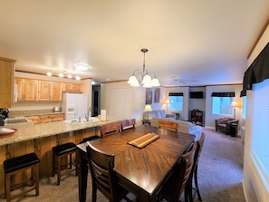 Enjoy meals together at the large dining table surrounded by comfortable chairs.