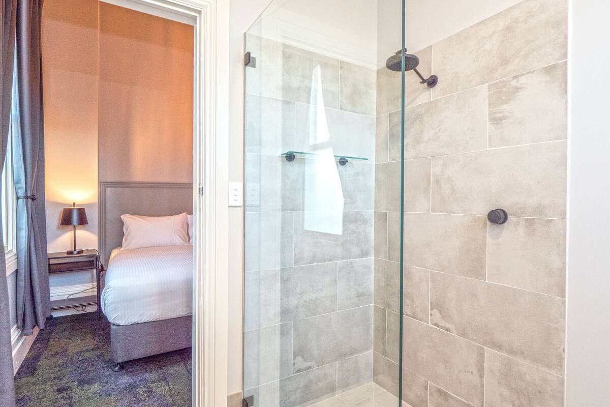 king room | bathroom | shower, hair dryer, towels