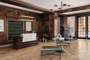 Experience the warm welcome at our lobby, featuring a reception desk, comfortable seating, and lush greenery.