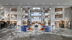 A spacious lobby with marble flooring, multiple levels, and modern seating areas. - Tolip Resort Elgalala Hills (Ataqah)