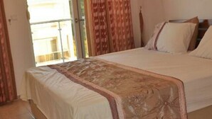 A bedroom with a bed, curtains, and a view through a glass door. - Beautiful Bright 3 Bed Home In Popular Sought After Private Gated Community (Manavgat)