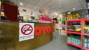 A store interior with a prominent 'OYO' sign, a no-smoking sign, and shelves stocked with bottled water. - Hotel O Bayu Sintok Motel (Changlun)