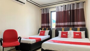 A hotel room with two beds, a red chair, and a window with striped curtains. - Hotel O Bayu Sintok Motel (Changlun)