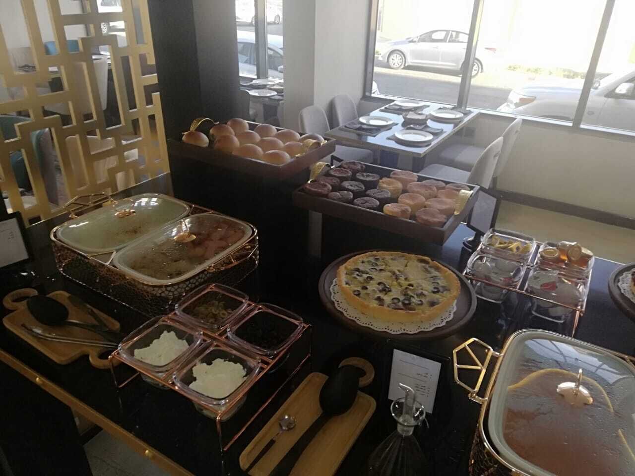A buffet with various food items and utensils.