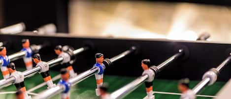 A close-up of a foosball table with miniature soccer players.