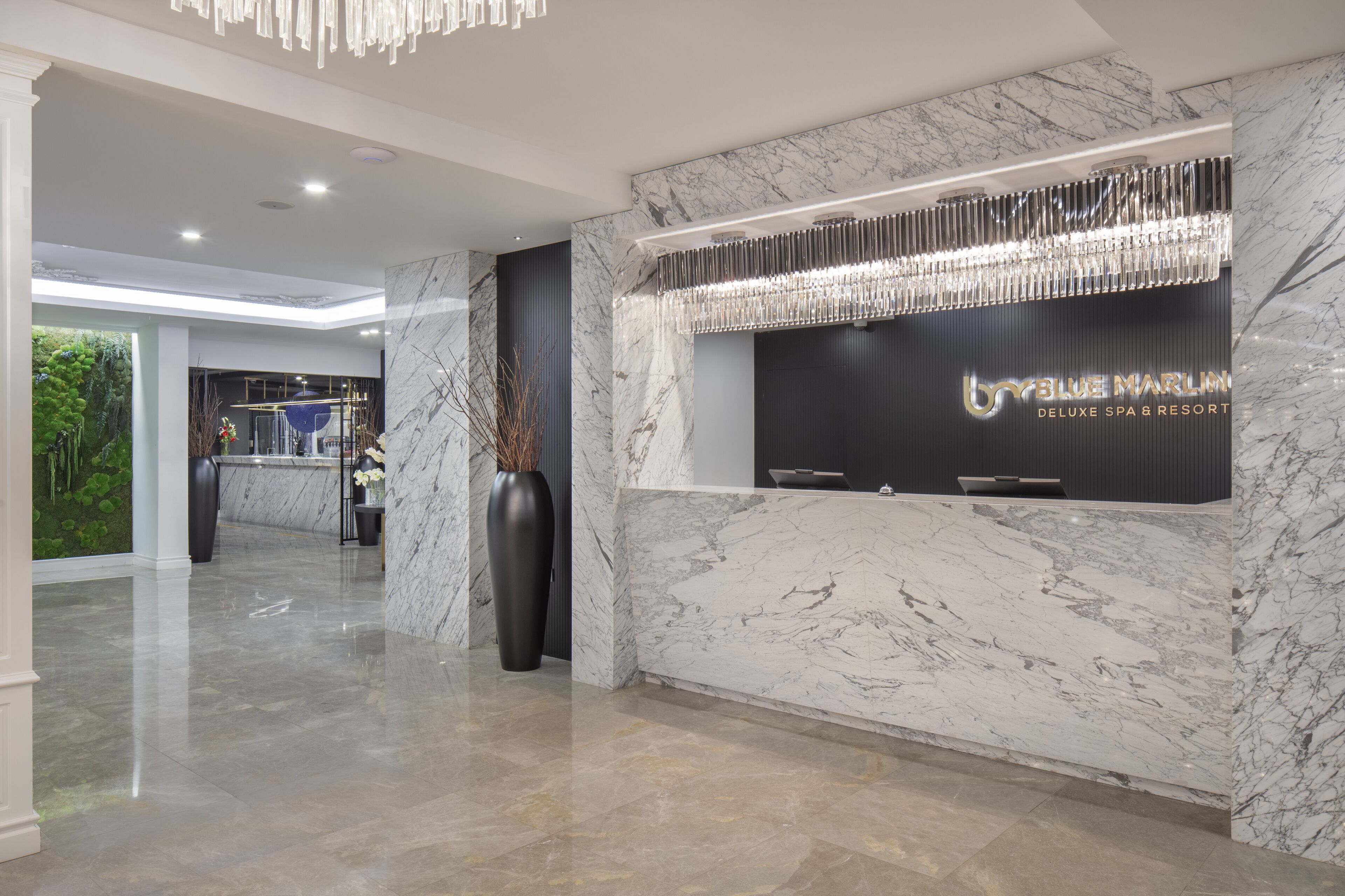 A modern reception area with marble walls and a reception desk.