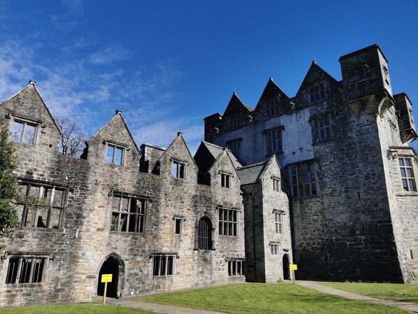 A historic stone building with multiple windows and a central entrance.