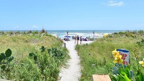 A beach path leading to the ocean with a sign indicating a keep-off zone. - Direct Oceanfront Magic at Sea Marsh w Pool (North Myrtle Beach)