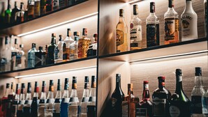 A bar with shelves of various liquor bottles.