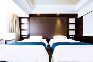 A hotel room with two beds, a large window, and a dark wooden headboard. - Beijing Happy City Hotel (Beijing)