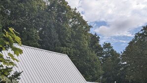A single-story building with a sloped metal roof, a stone foundation, and a small porch area. - Beautiful house on the Paradise Eckerman boarder. (Eckerman)