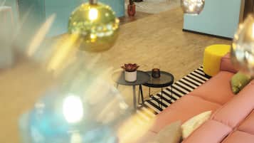A modern living room with a sofa, a coffee table, and decorative items.