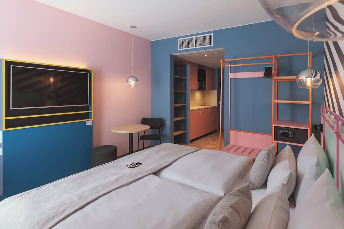 premium room, 1 queen bed, kitchenette | in-room safe, desk, soundproofing, free cots/infant beds