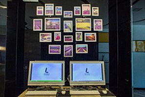 Work in comfort with two computer monitors and a wall-mounted display showcasing a curated collection of photographs.