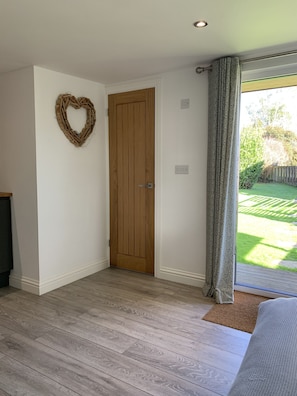 Enter a cozy space with a heart-shaped wall decoration and a window with a patterned curtain.