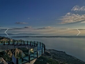Enjoy panoramic views of the vast body of water and distant landforms from this elevated observation platform.