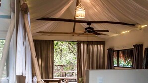 Une pièce avec une balançoire en bois, un ventilateur de plafond et un luminaire suspendu.