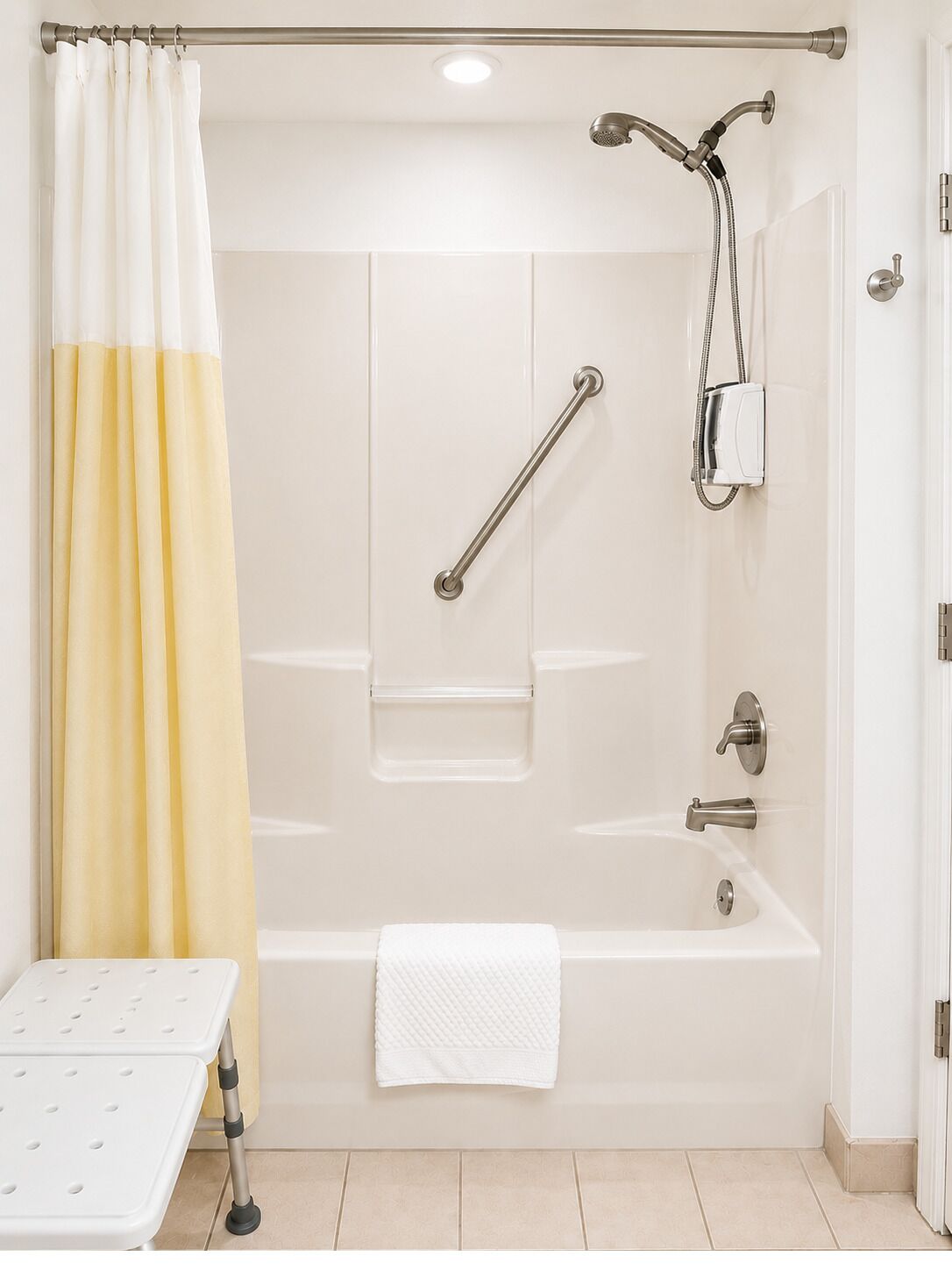 A bathroom with a bathtub, shower, grab bar, and a white towel.