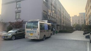 A building with a sign that reads "LAVANDE" and a bus parked in front. - Lavande Hotels (Hangzhou Xiaoshan International Airport) (Hangzhou)