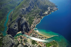 A coastal town with a river, steep cliffs, and a beach. - Luxury apt w Pool, 3 Balconies, Terrace & sea View (Omis)