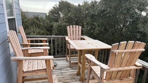 A wooden deck with a table and chairs. - 3 Bed/2.5 Bath 1450 sq ft with Large Open Floor Plan, 3 Min Walk to Beach (Emerald Isle)