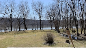 A wooden deck with a view of a lake and trees. - Private cottage on Susquehanna river Very private !! (Berwick)