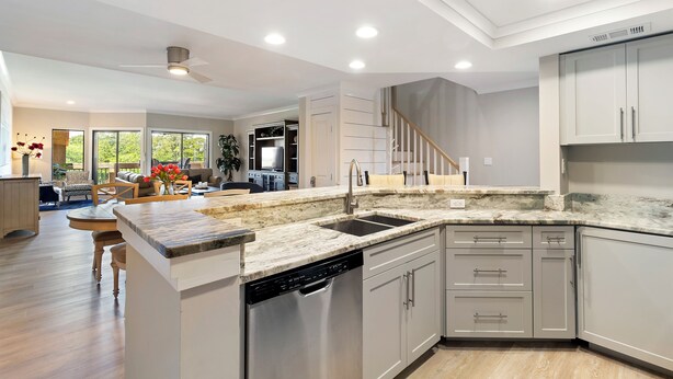 A modern kitchen with white cabinetry, a granite countertop, and a dishwasher. - Water & Marina Views, Pet Friendly-Near Beach (Hilton Head Island)